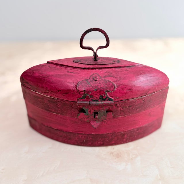 Measurements: 8.75"W x 5"T x 4"D A domed storage box hand-painted in a rich raspberry-red with visible brushwork and a...