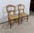 Pair of Louis-Philippe chairs in solid beech resting on shot feet, connected by a also turned bar. The "saber" feet at the...