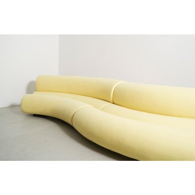 The Celeste is a contemporary and sleek yet functional sofa with sinuous curves and plump bolsters in light yellow wool...