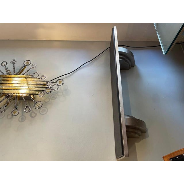 1980s Art Deco wall shelf with decorative silver-plated metal brackets and a recessed black marble shelf with a rustic...