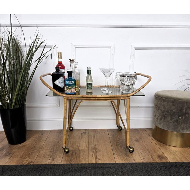 1970s Italian Mid-Century Modern serving bar cart trolley with glass top. This charming piece is in the typical style of...