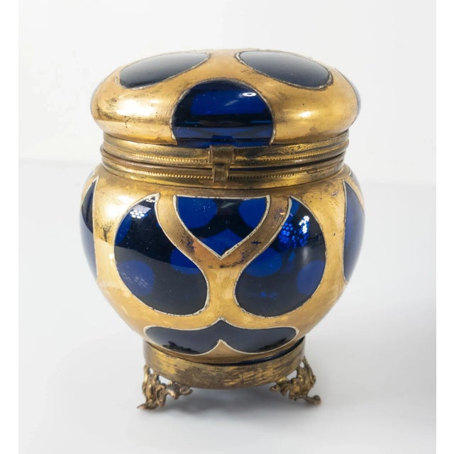 We are selling this gorgeous glass trinket or jewelry box. This European box is probably French or Bohemian and has a dark...