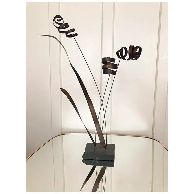 This Kinetic Cattail Sculpture is a striking combination of movement and structure. Crafted from robust metallic...