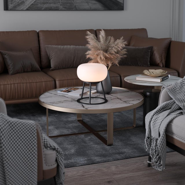 TRIPOD - where sculptural design meets luminous artistry. This statement piece features a striking white oval-shaped glass...