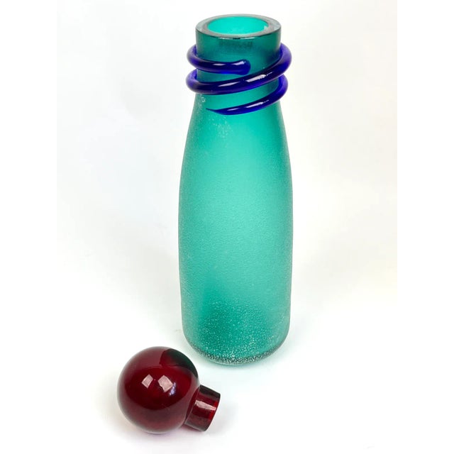 A striking decanter made by Alfredo Barbini for Murano in the Scavo glass technique. Featuring a cobalt blue serpentine...