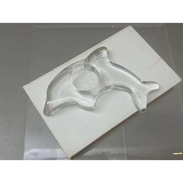 A sculptural candle holder by Glasi Hergiswil, crafted from thick-walled clear glass with an organically shaped...