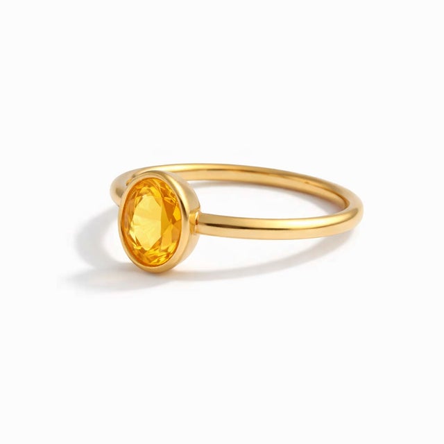 Oval Citrine Solitaire Ring in Gold Elegant in its simplicity, this ring features a radiant oval-cut citrine set in a...