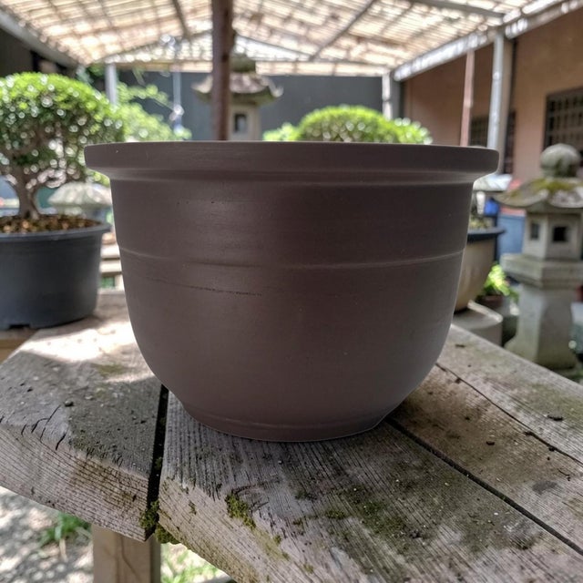 Chinese Yixing Zisha/Tokoname bonsai pot of circular form with an unglazed finish dating most likely from the 1980s–2000s,...