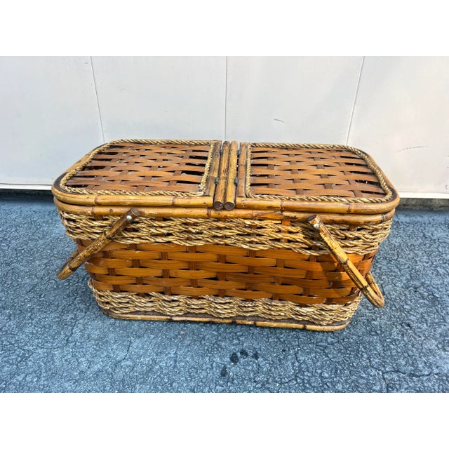 A fantastic picnic basket circa 1970’s. Scorched bamboo handles, wooden construction, woven wood surrounded, and a jute...