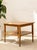 A charming vintage side table featuring a warm wood finish and a practical two-tier design. The square tabletop showcases...