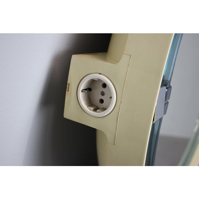 Rare Mid-Century illuminated wall mirror by Allibert, manufactured in Germany during the 1960s. The mirror features a...