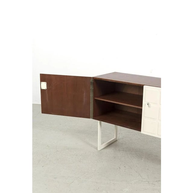 Extraordinary 2-door cabinet with white checkered doors that can be locked with matching keys. The cabinet has one shelf...