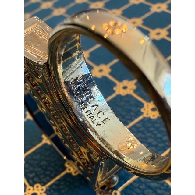 This ring announces your entrance before you even open the door! This Retro Versace cocktail ring has an encased blue...