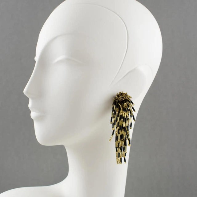 These stunning dangling glass clip-on earrings, shaped like a lionfish, feature an oversized shoulder-duster design and a...