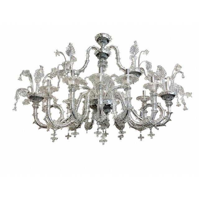 Venetian rezzonico chandelier in clear blown glass with 12 lights and 12 arms, entirely handcrafted according to the...