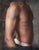 This oil painting presents a close-up view of a male torso, emphasizing the play of light and shadow across the sculpted...