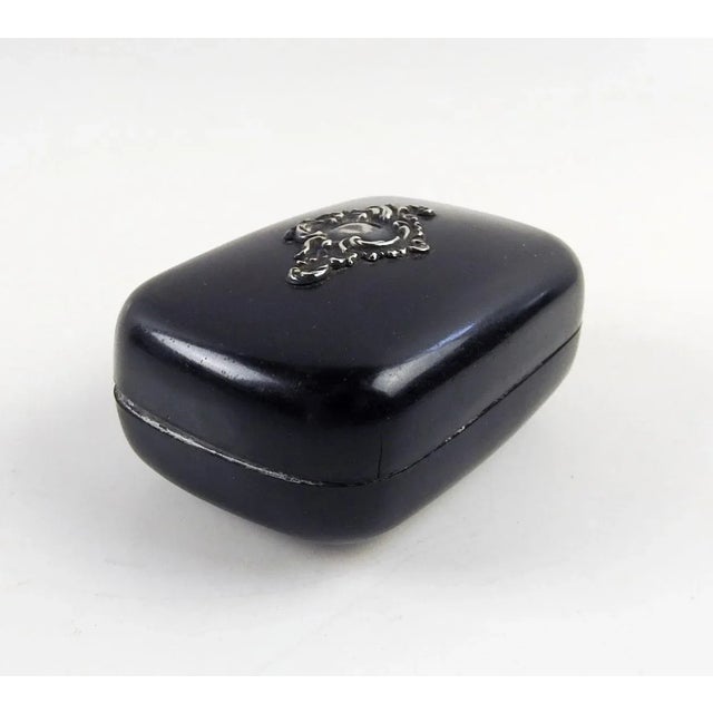Circa 1900's black celluloid dresser or pin box with sterling silver embellishment. Smooth satiny surface, overal patina...