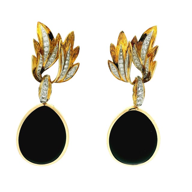A dramatic pair of vintage Italian 18K gold, onyx, and diamond drop earrings showcasing the bold elegance of late 20th-...