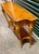 The most striking feature of this table is its tabletop, which boasts a sophisticated patterned inlay. This marquetry...