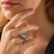 This modern engagement ring is centered around a striking 6.10 carat pear shape diamond certified by GIA under report...