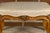 A French Louis XV style walnut footstool from the 19th century with custom linen upholstery. This exquisite 19th-century...