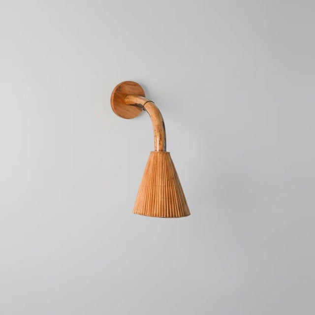 Designed by Nory Mae Parry, the Cone 002 Wall Lamp is a study in restraint. Pencil reed rattan is placed with precision to...