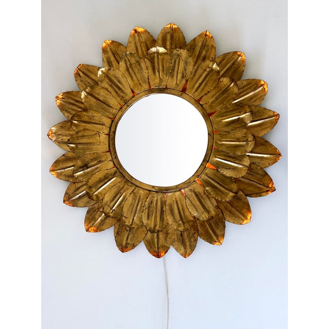 Large, exceptional and highly decorative mid century modern sunflower backlit wall mirror. Designed and manufactured in...