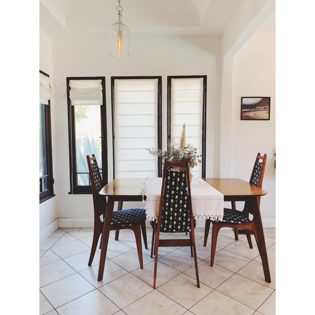 A sculptural set of four Danish Modern dining chairs crafted in solid teak, circa 1960s. These chairs feature elegantly...