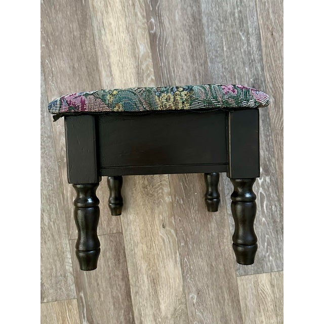 Vintage wooden footstool with storage. Solid wood base and upholstered top with a watercolor style floral tapestry fabric....