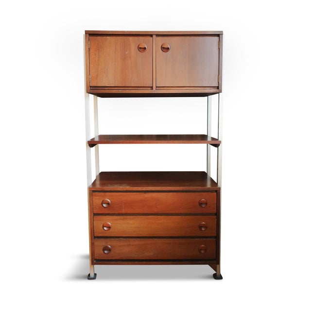 A fantastic pair of modular wall units by Stanley featuring walnut veneer cabinets and drawer fronts supported by silver...