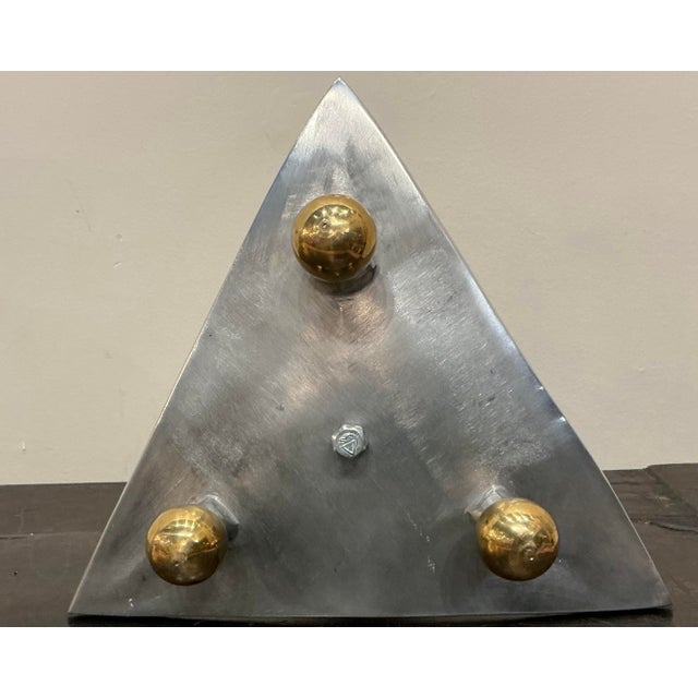 Material and form embodies a modernist or industrial aesthetic often associated with MCM or 1970's design.