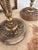 Substantial pair of vintage three-arm candelabra featuring richly ornamented brass-tone metalwork and polished natural...