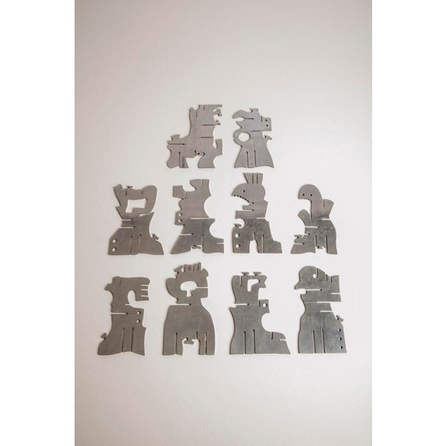 Modular sculpture made up of ten shaped aluminum plates of different shapes, interchangeable with each other to create...