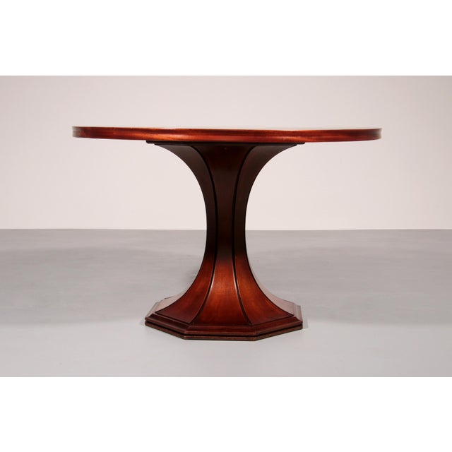 A remarkably rare round extending dining table designed in the 1960s by the celebrated Italian architect and furniture...