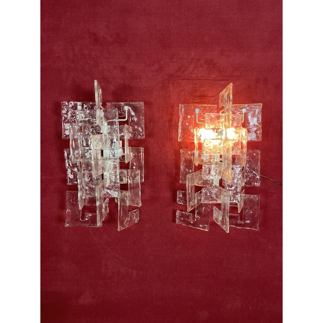 Set of 2 Murano glass wall lamps 1960s Glass elements, all worked by hand, are attached to the painted metal structure....