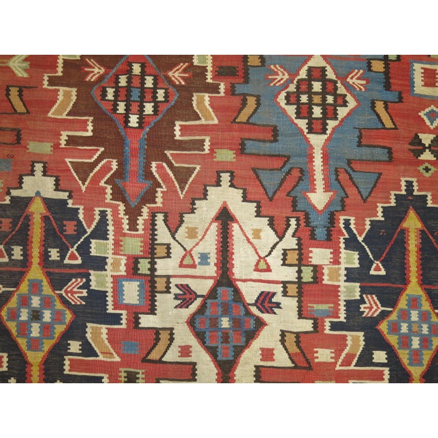 An intermediate size tribal Caucasian Shirvan rustic Kilim from the early 20th century Measures: 4'10'' x 9'1".