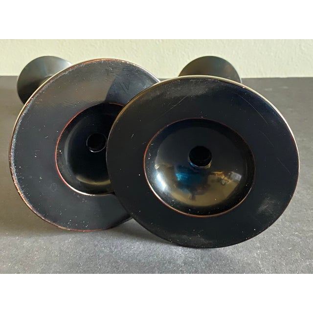 A truly wonderful pair of c1910 black lacquer Japanese candlesticks with enameled floral decoration.