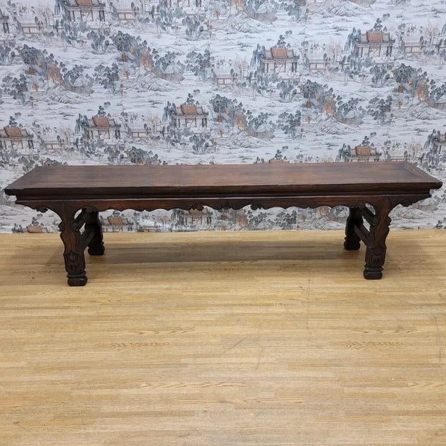 Antique Shanxi Province Bench Antique bench from Shanxi, featuring a long rectangular top with carved scrolling motifs and...