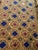 Hand-embroidered Suzani panel from Uzbekistan — a golden lattice enclosing cobalt blue diamonds, with animal and vessel...