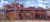 Burnham Yards by Delton Demarest | Oil on Board Painting of an industrial yard with buildings. For Sale