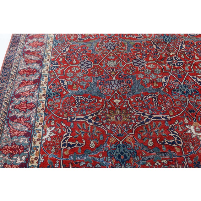This early 20th-century Persian Tehran rug is a paragon of Persian craft. The rich red field carries an allover trellis of...