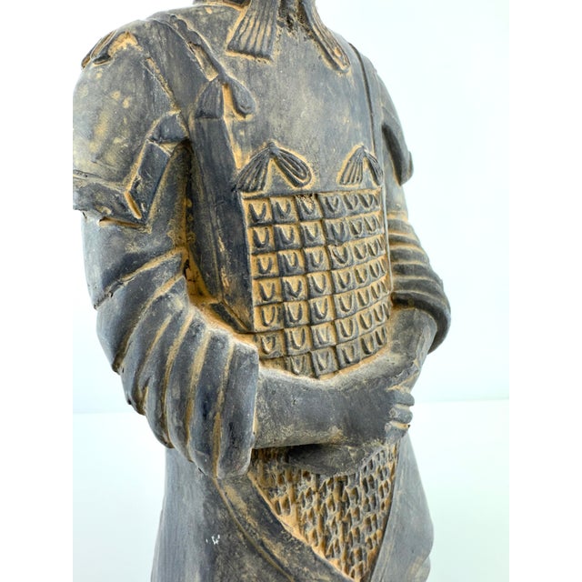 Vintage Chinese terracotta warrior figure, modeled after the iconic Qin dynasty soldiers, featuring detailed armor,...