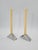 An elegant pair of modernist candlesticks made of polished aluminium, with a distinctly sculptural, geometric form. The...