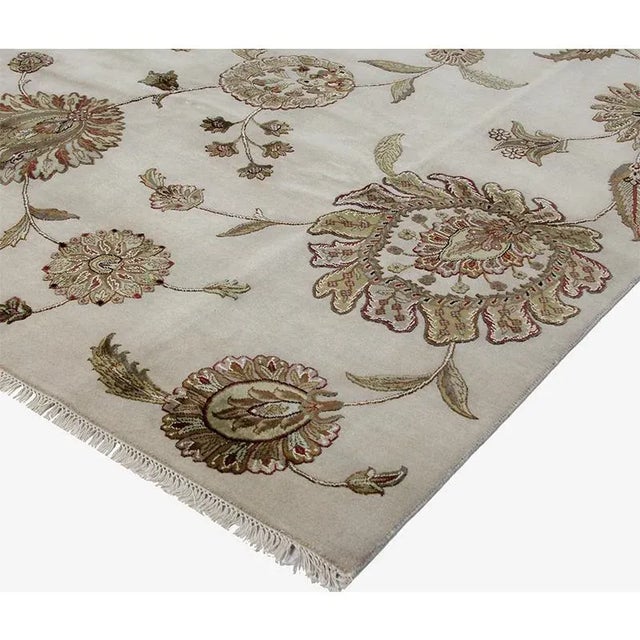 This transitional hand-woven Persian Tabriz style Indo rug features a Jaipur design beautifully embellished with a...