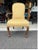 Classic Queen Anne style armchair featuring gracefully curved cabriole legs with carved details and a warm polished walnut...