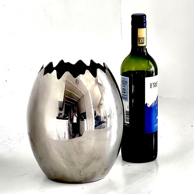 Offered is a chic and sleek yet whimsical polished stainless steel "Ovo" egg shaped vase/ice bucket made by Mepra in...