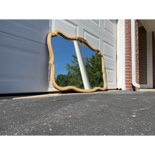 An exceptional vintage French Provincial mirror, attributed to Drexel Heritage, crafted in the 1970s. This striking piece...