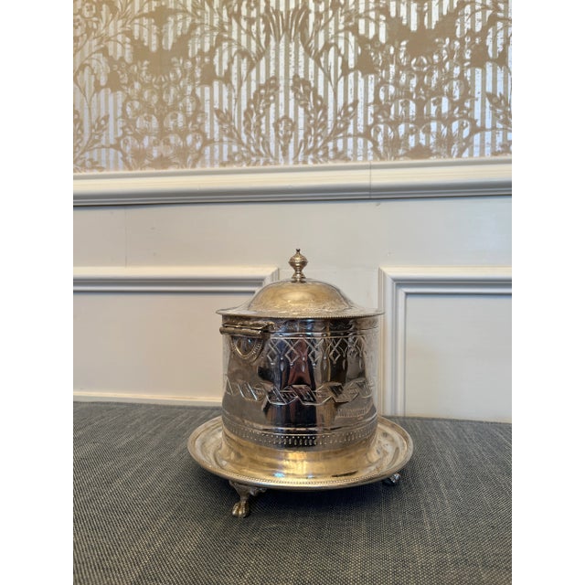 Beautiful English silver plate covered biscuit box/tea caddy with attached footed gallery tray. The Caddy is in good...