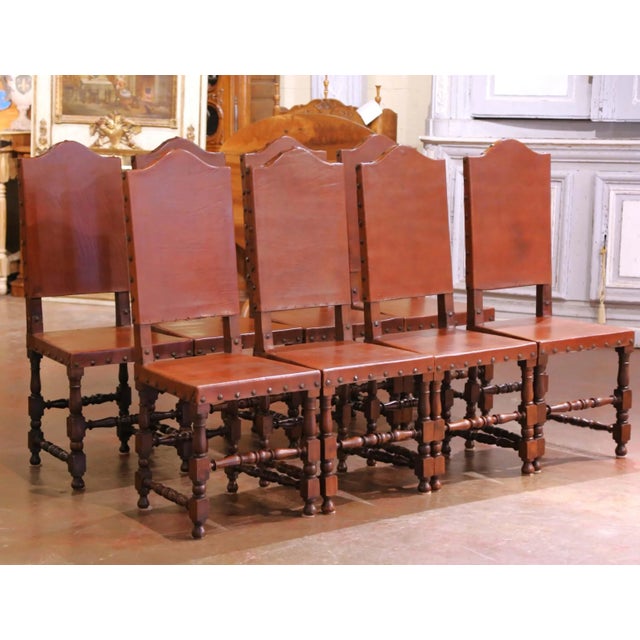 Crafted in Spain circa 1880, this complete set of eight antique dining chairs combines sturdy oak construction with richly...