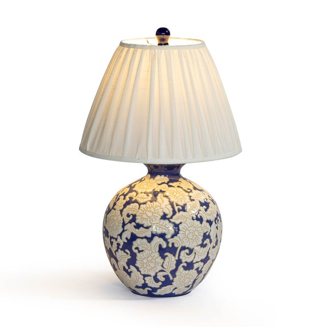 The Diana Blue and White Table Lamp brings timeless pattern and personality to your space. Its hand painted base features...